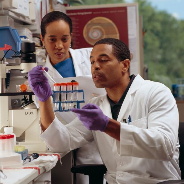 man in white chef uniform holding purple plastic bottle